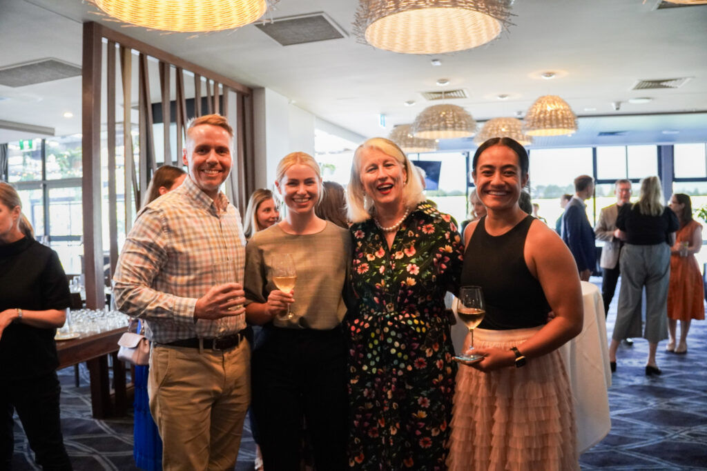 Photo of one x Director of Marketing at an event with Local Partners and Communities.